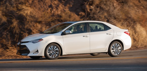 A white Toyota Corolla, a compact sedan.