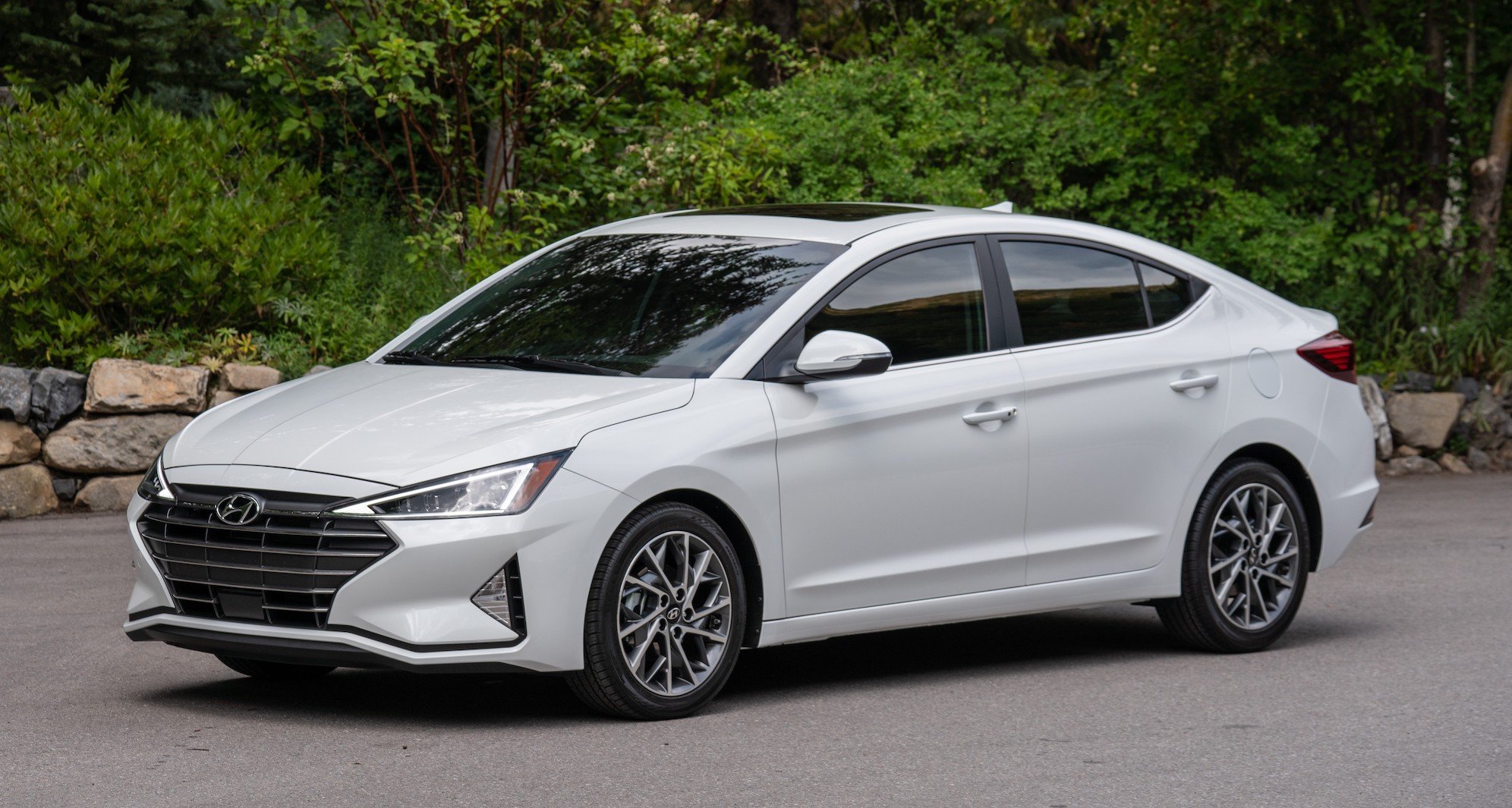 A white Hyundai Elantra, a compact sedan.