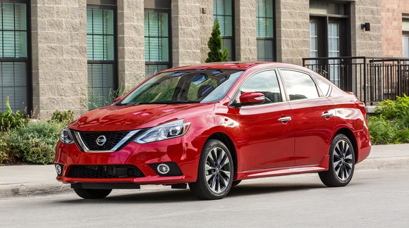 A red Nissan Sentra, a compact sedan.