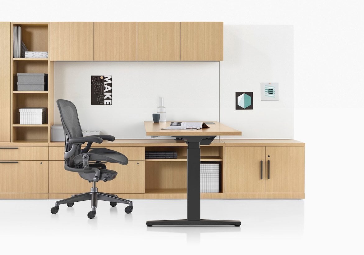 Contemporary chair next to a desk and shelving in wood.
