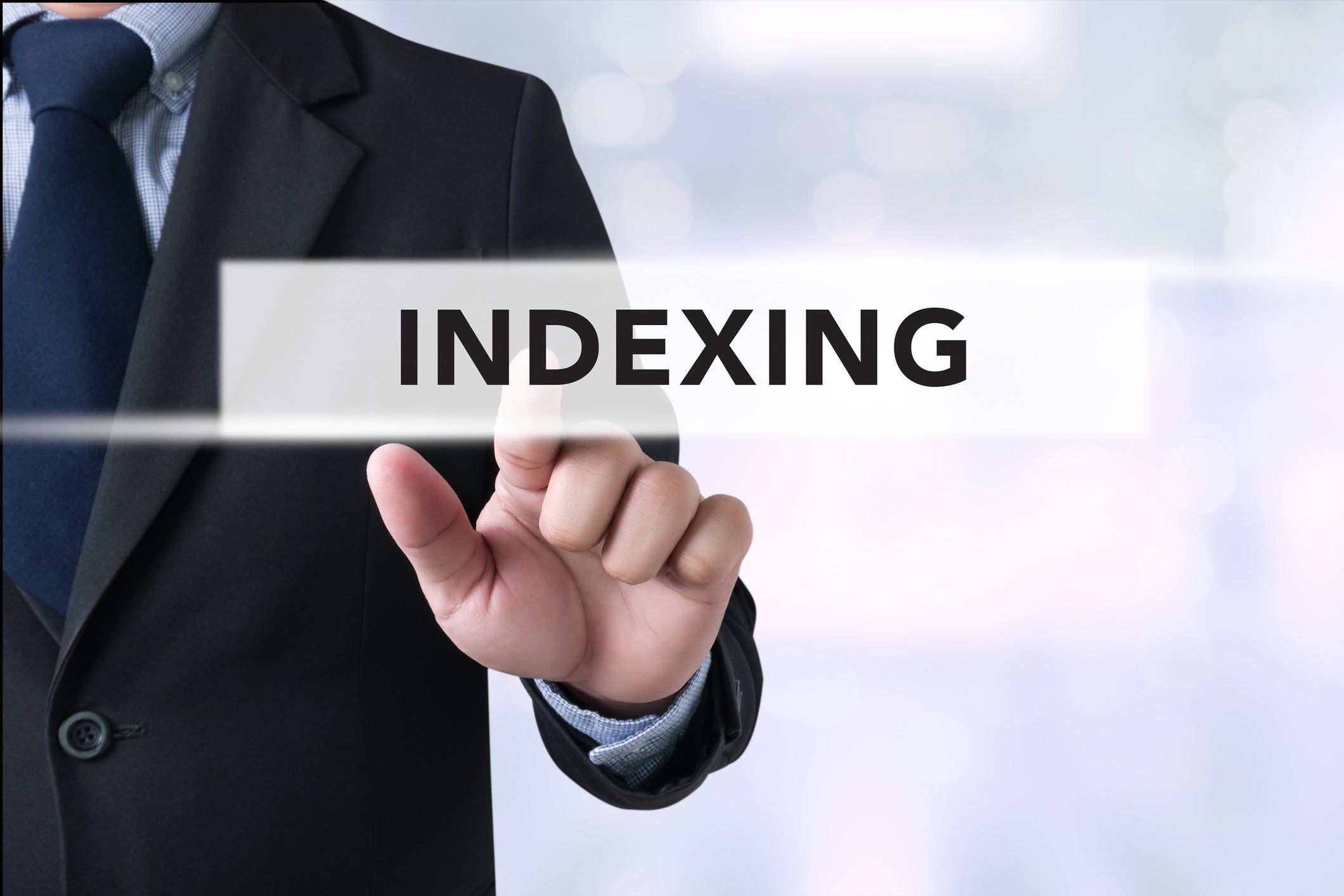 We see part of a man in a suit, pointing to the word indexing, that's floating in front of him.