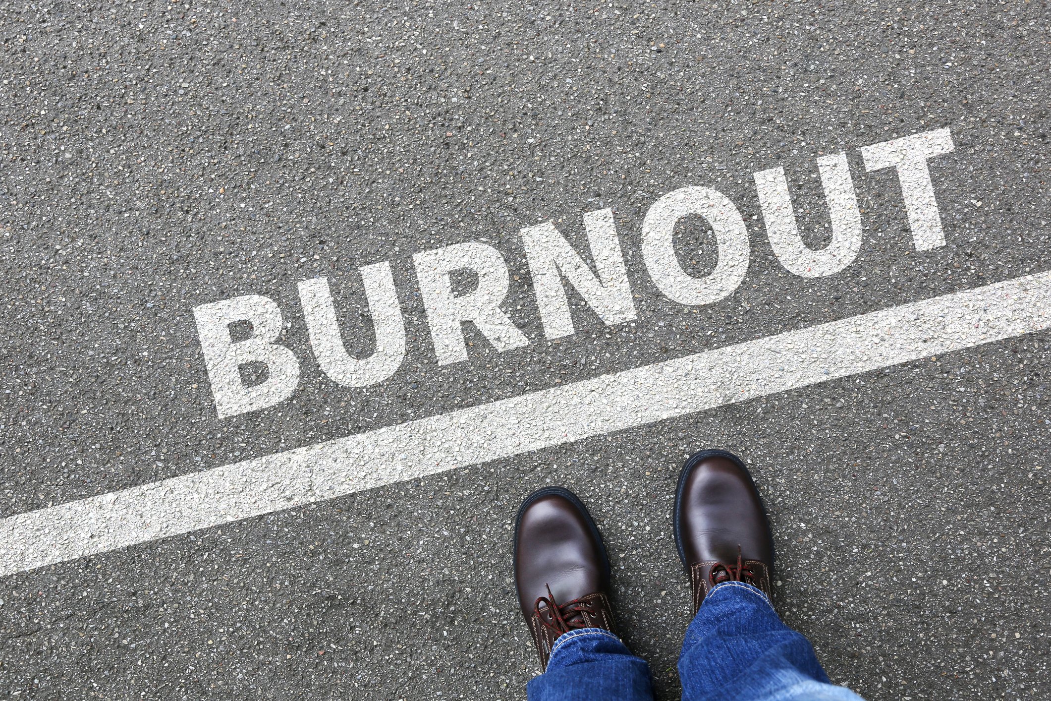 A person stands on a line that says burnout.
