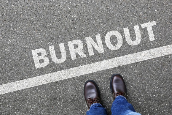 A person stands on a line that says burnout.