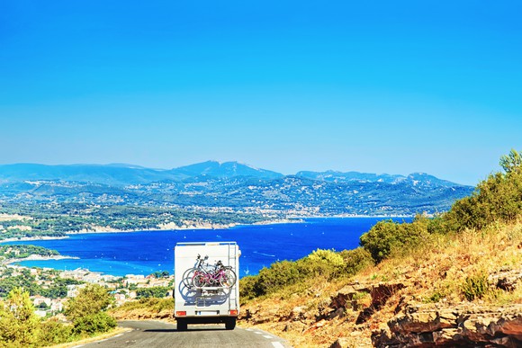 RV driving down scenic road in the south of France coastal region.