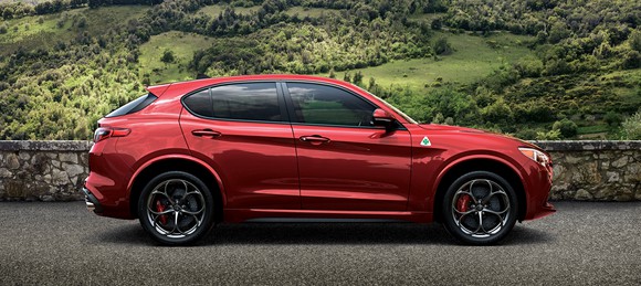 A red Alfa Romeo Stelvio, a high-performance 5-passenger luxury-sports crossover SUV.