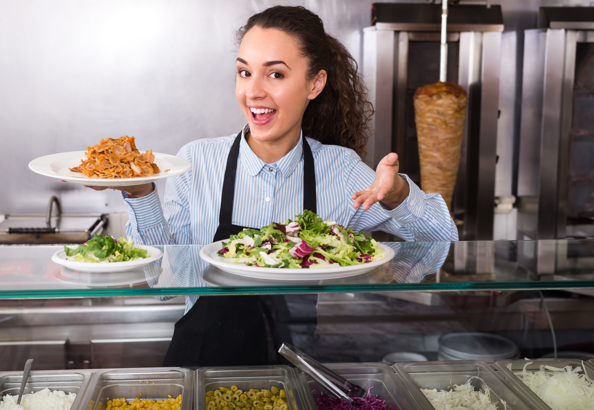 A chef presents meals from the kitchen.