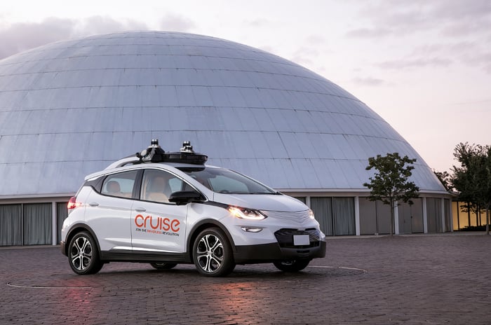A GM Cruise self-driving vehicle, a white hatchback with visible self-driving hardware.