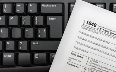 tax form on keyboard_GettyImages-1066675918