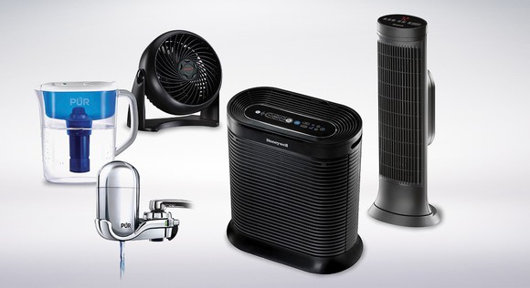 A water purifier system and three fans against a white backdrop.