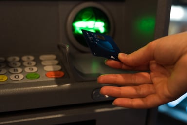 Woman Inserting Card in ATM