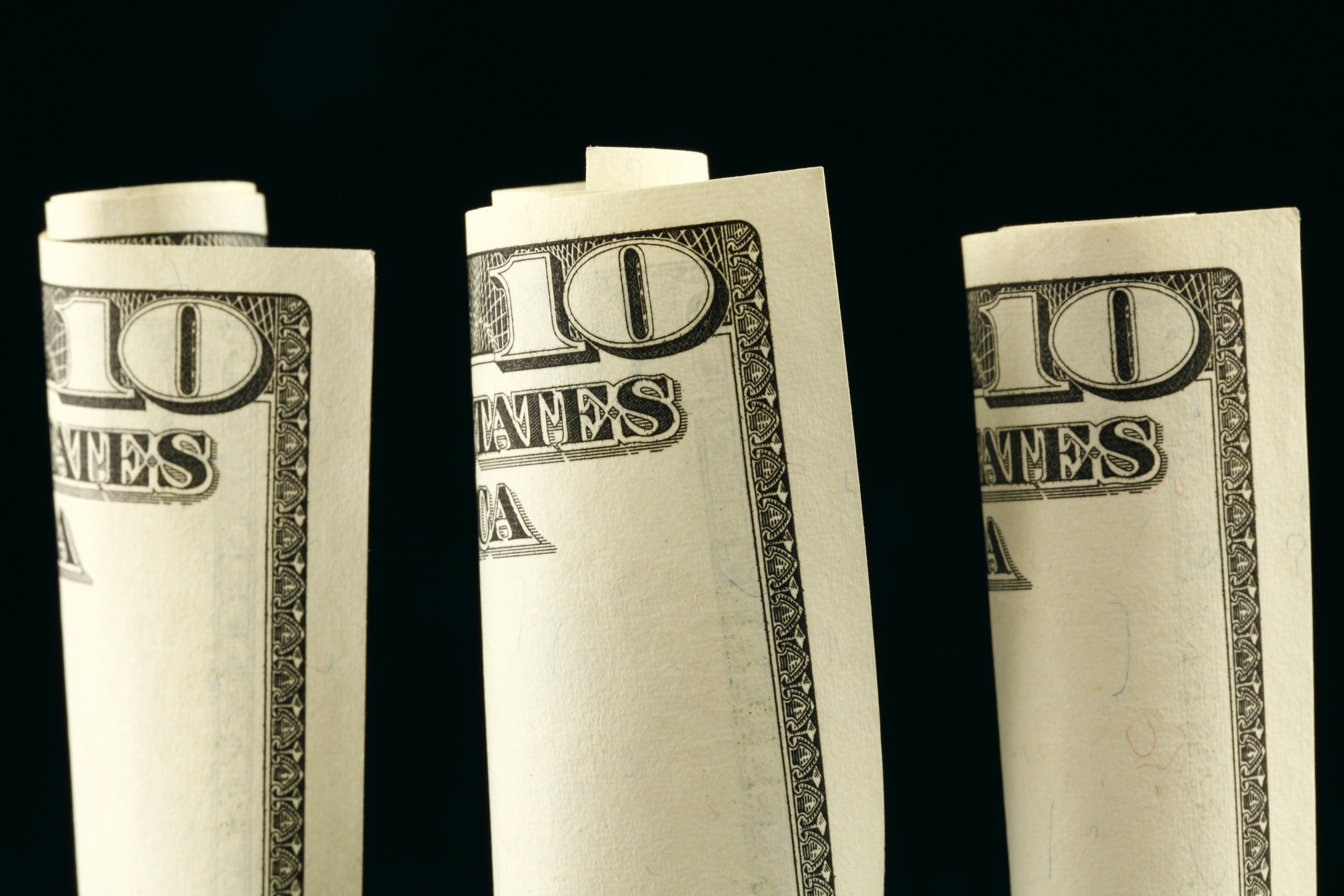Three rolled-up $10 bills.
