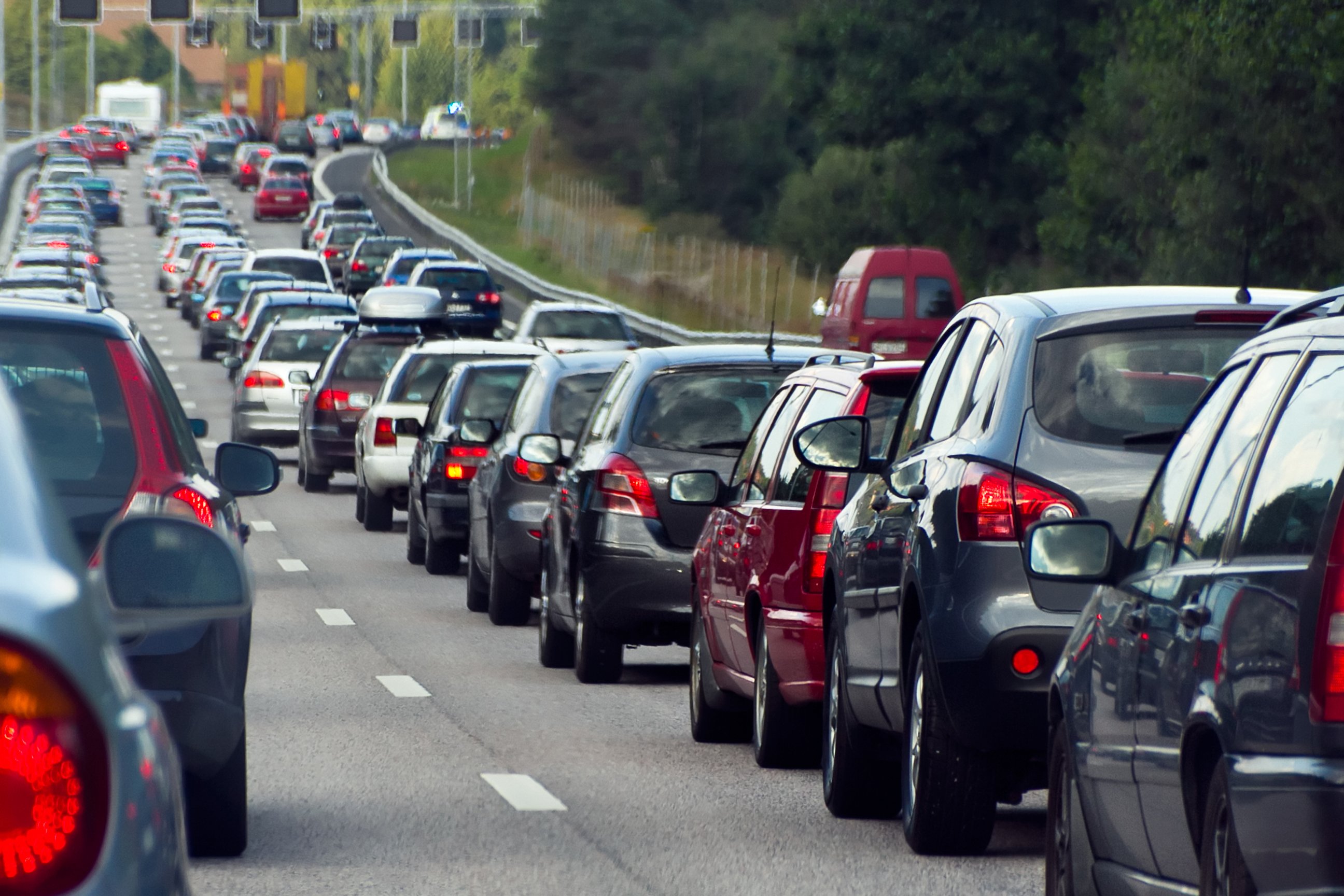 Two lanes of freeway traffic with cars stopped