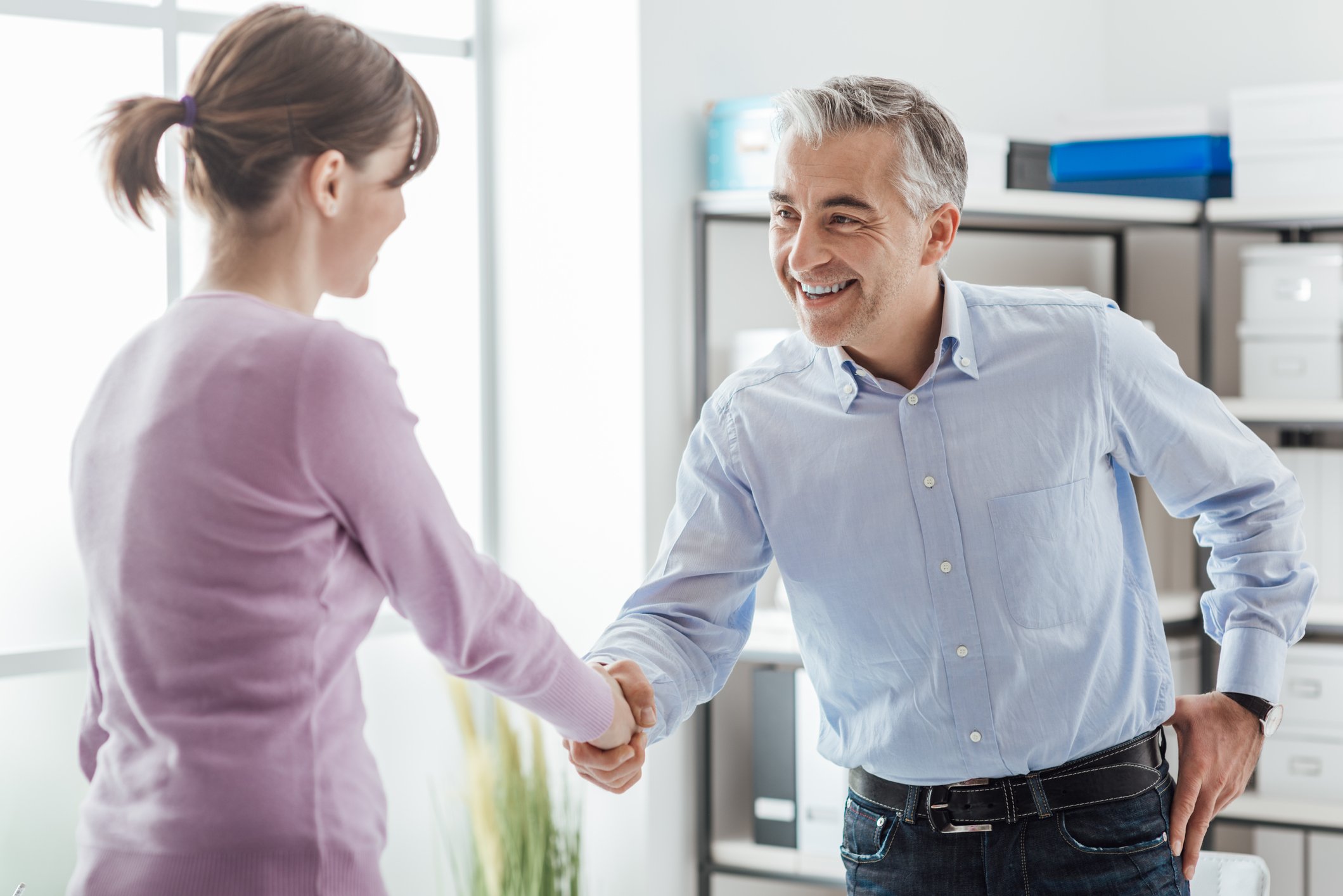 Man and woman shaking hands.