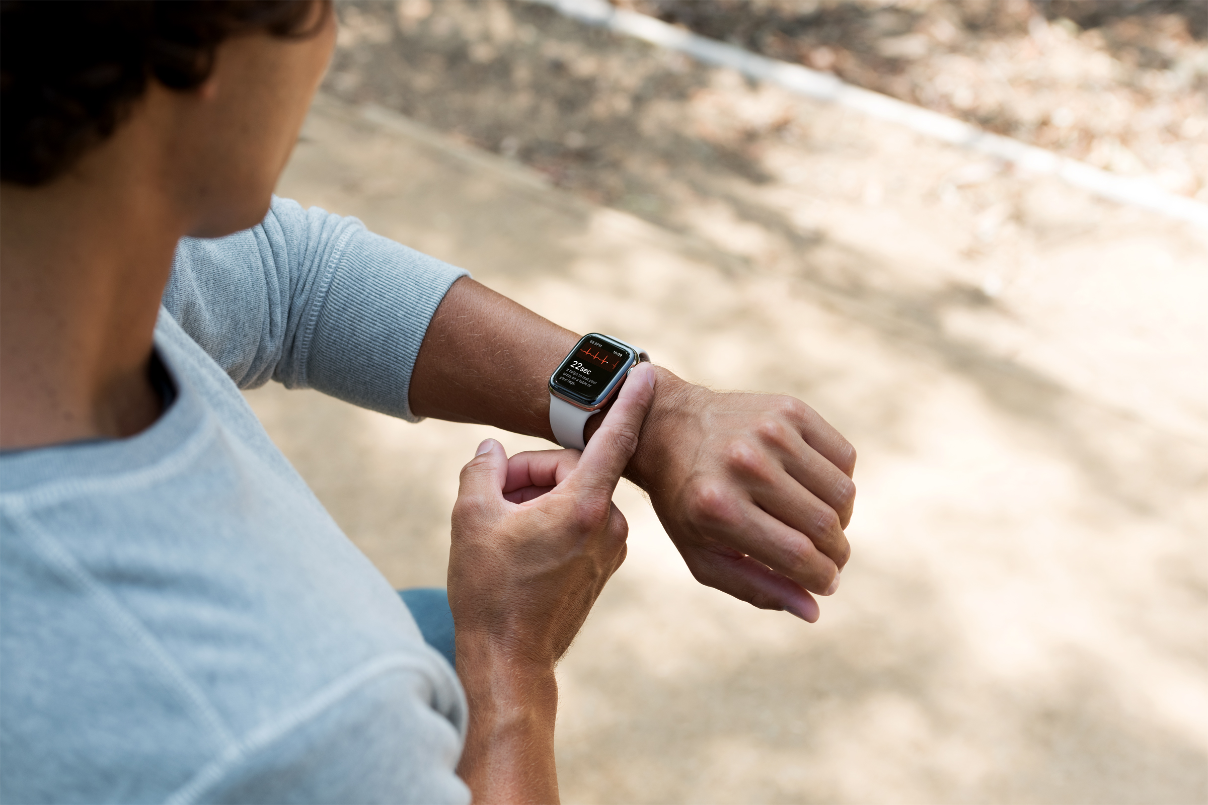 A man taking an ECG on the Apple Watch.