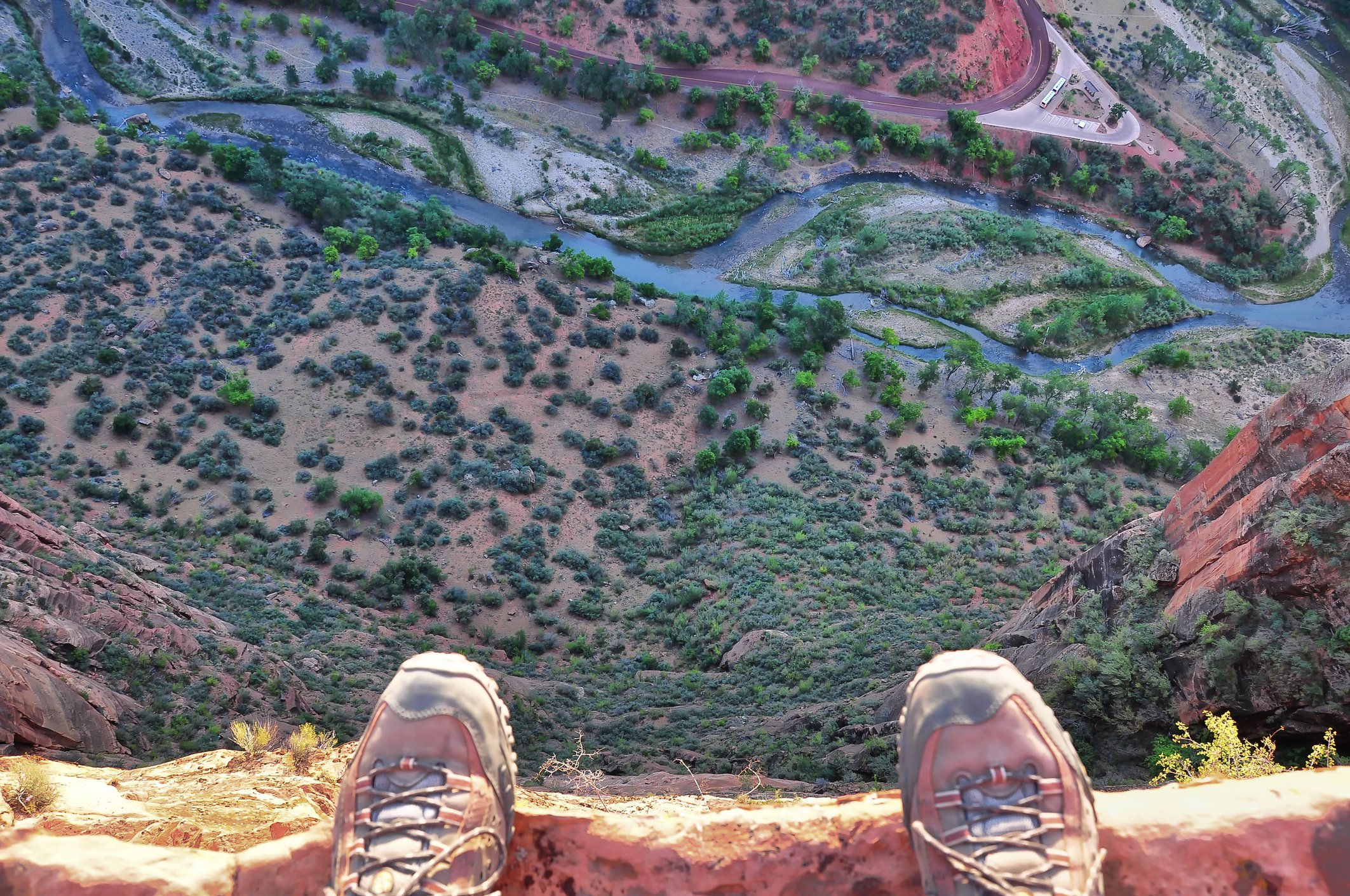 A pair of shoes on the edge of a cliff.