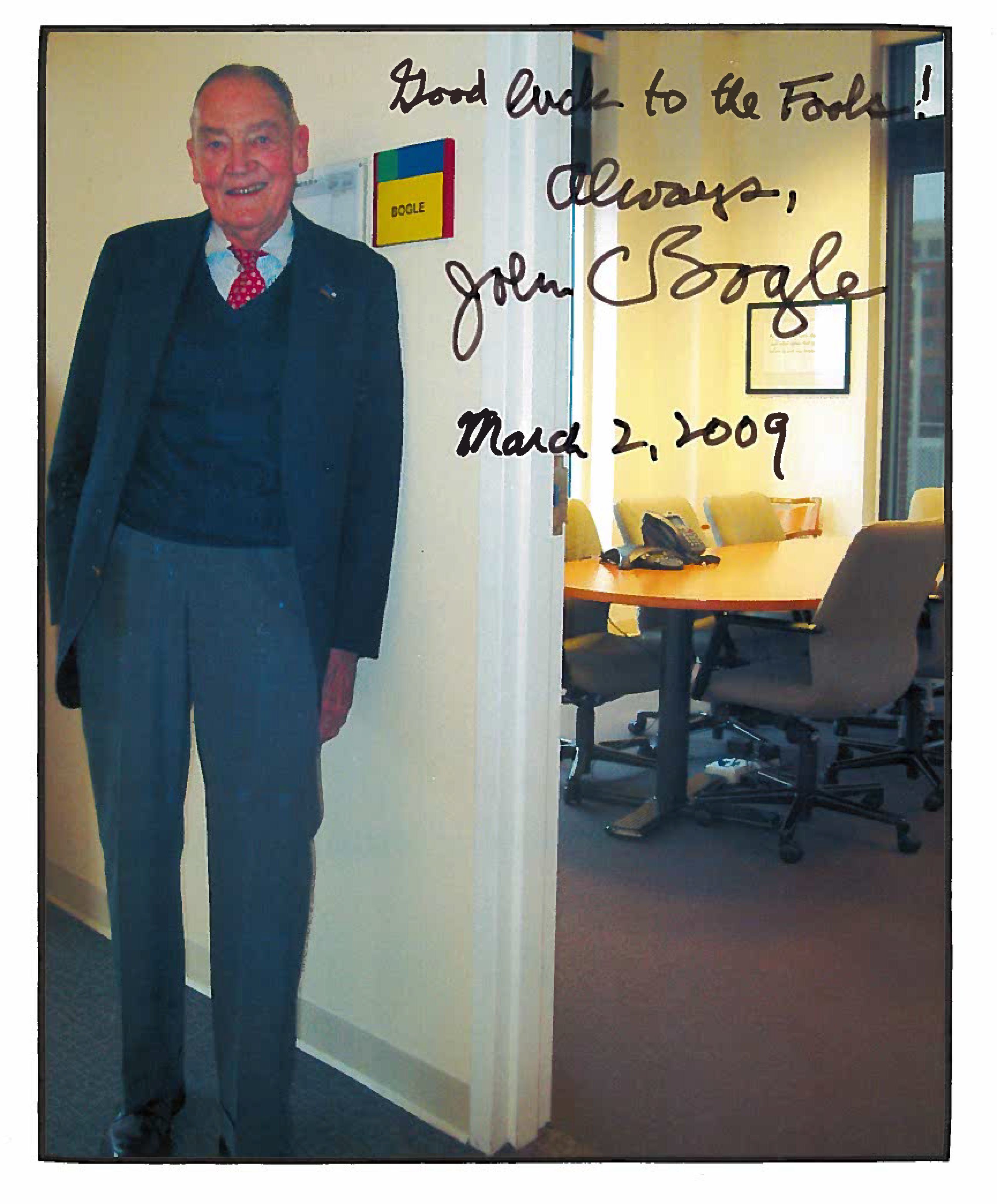 Jack Bogle standing outside The Motley Fool conference room named for him.