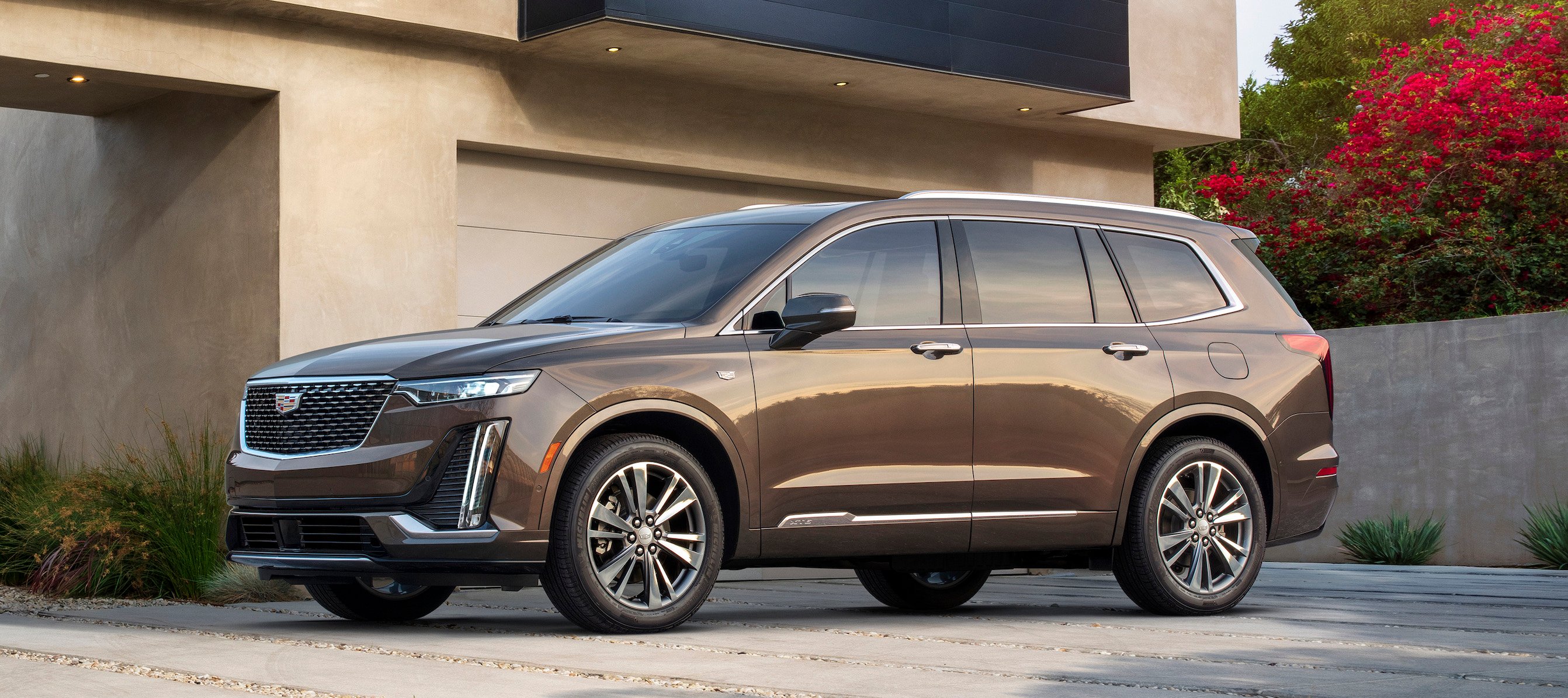 A brown 2020 Cadillac XT6 in Premium Luxury trim. It has smaller wheels and subtler styling cues than the Sport version pictured above.