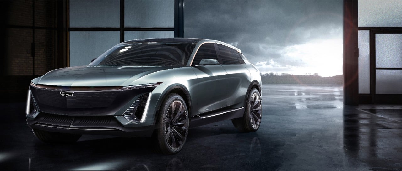 A futuristic gray midsize Cadillac crossover SUV is shown in a three-quarter view. 