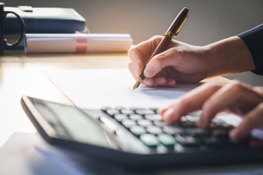 man using a calculator_GettyImages-654694640
