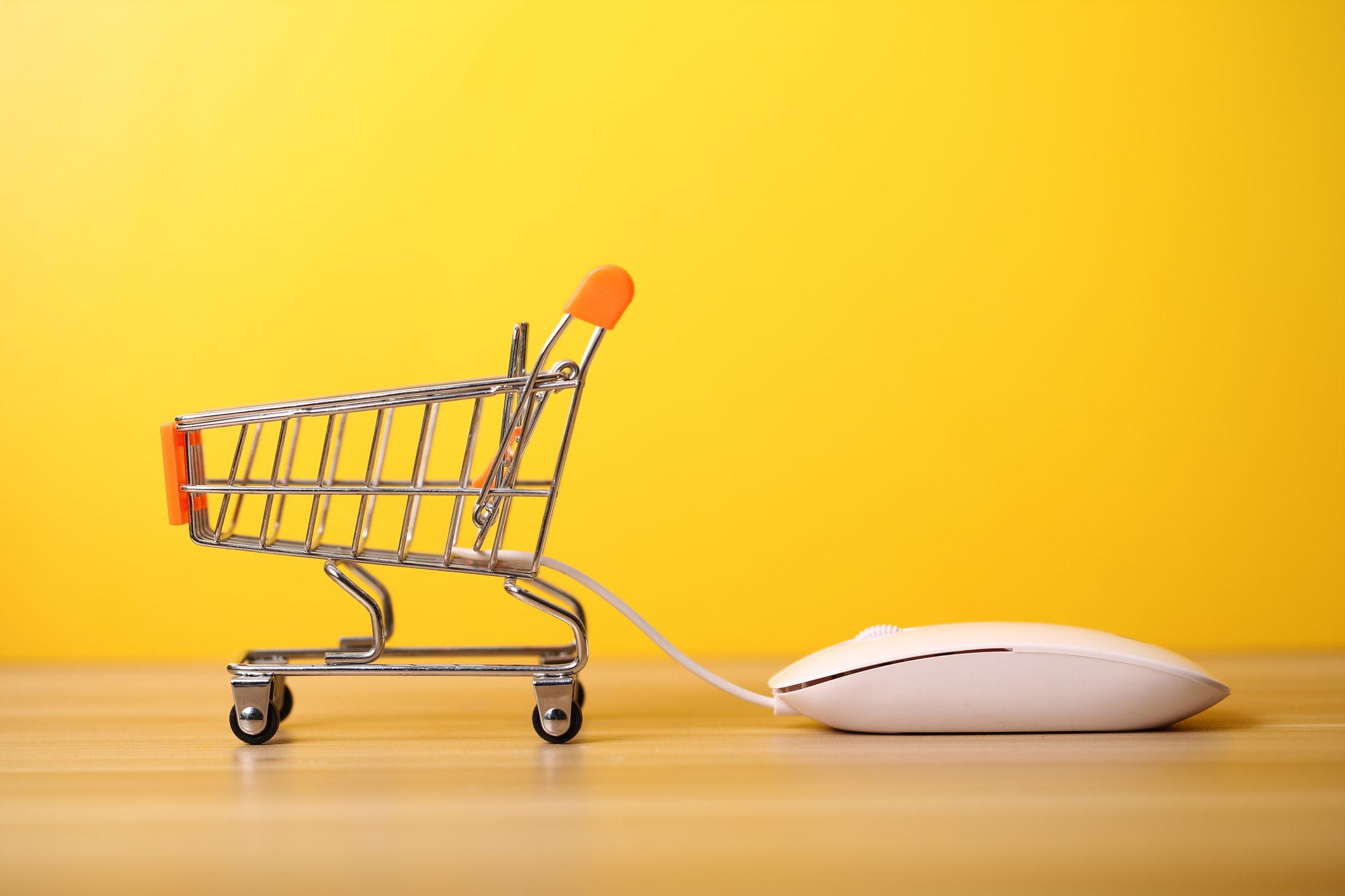 A shopping basket connected to a computer mouse.
