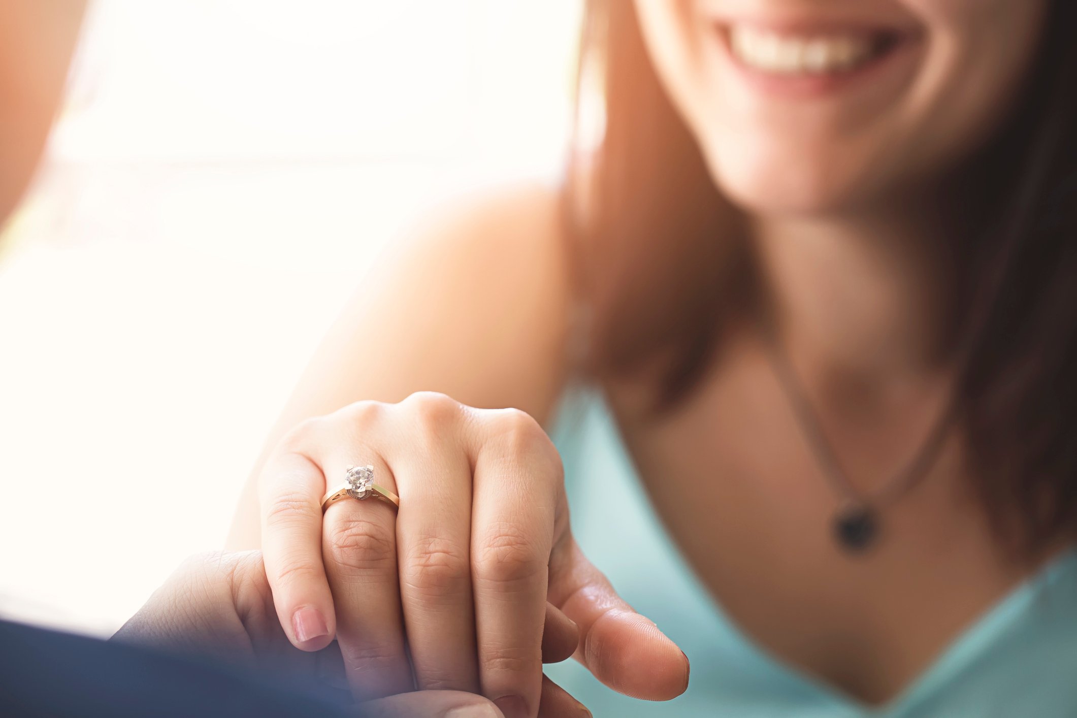 A woman shows off her engagement ring.