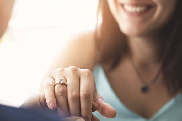 A woman shows off her engagement ring.