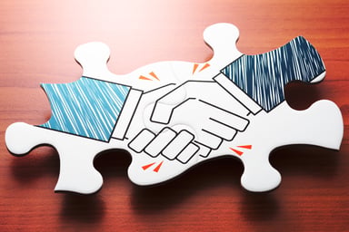 Jigsaw puzzle piece with hands shaking