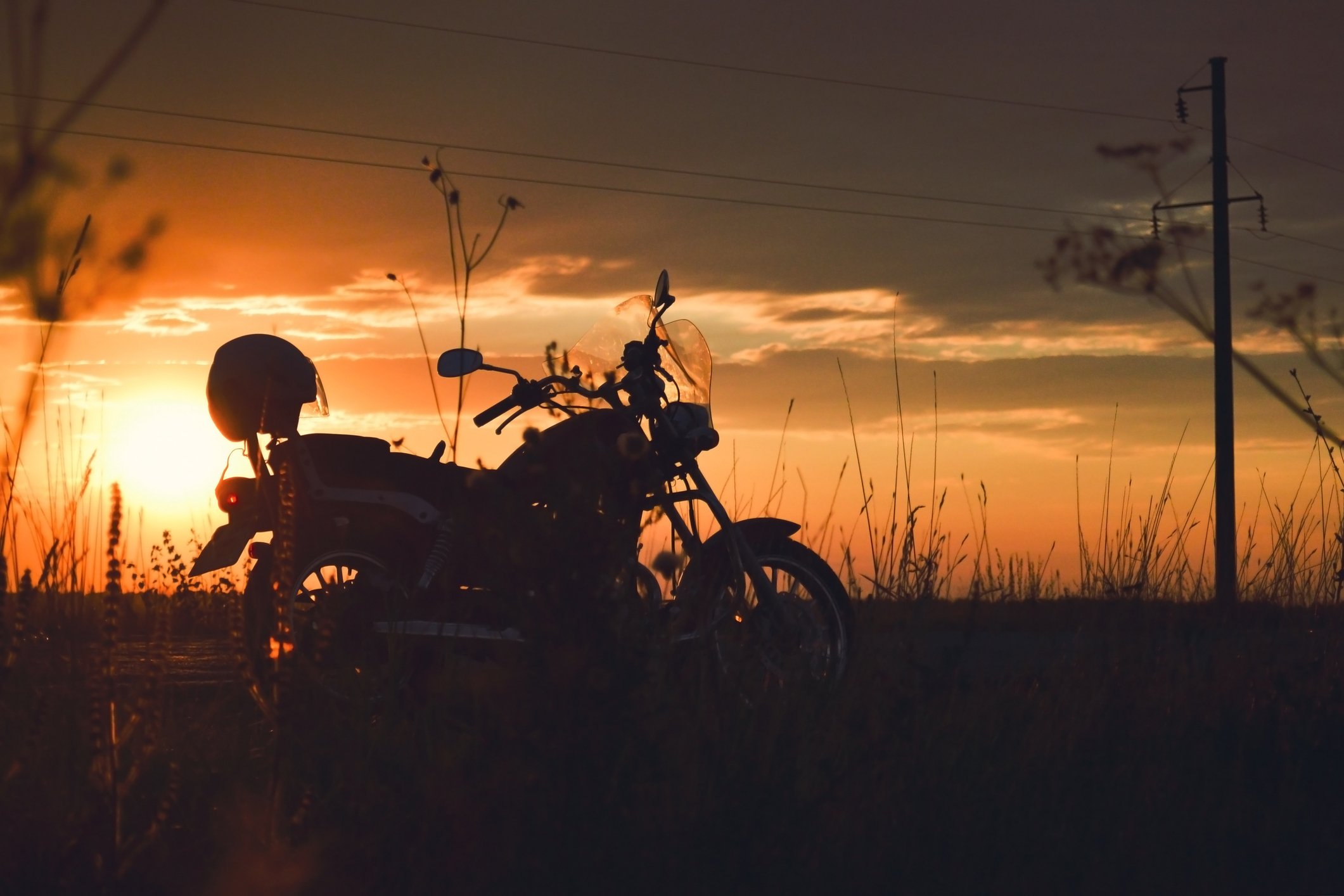 Motorcycle in silhouette at sunset