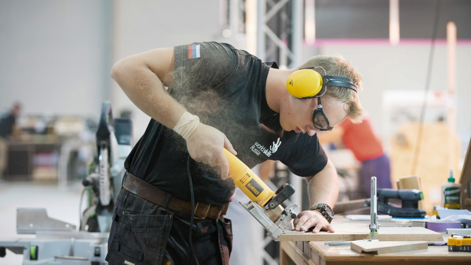 A man using a Stanley Black & Decker tool. 