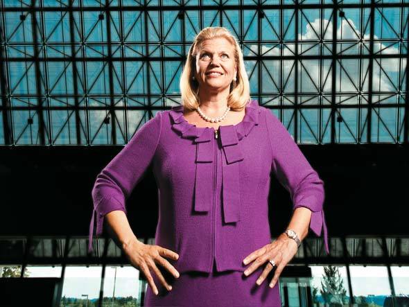 IBM's CEO, Ginni Rometty, smiling with arms akimbo in a purple dress.