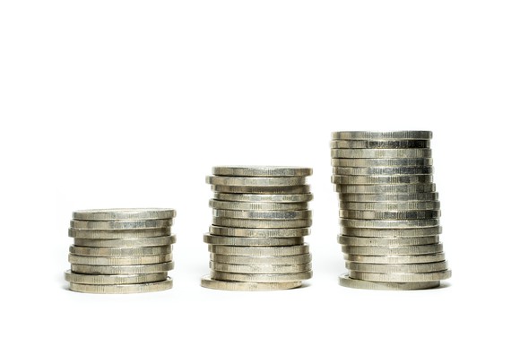 Stacks of successively taller coins, suggesting a rising stock chart.