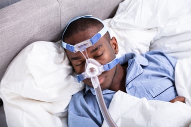 Man with CPAP machine on his face