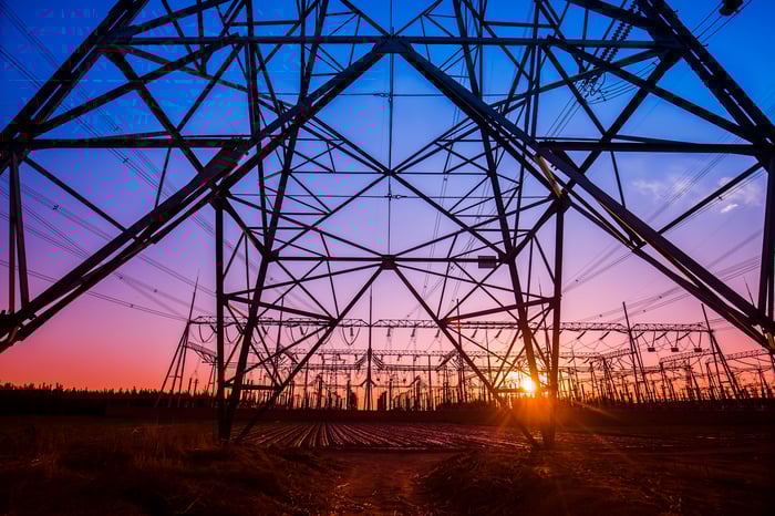 An electricity transmission pylon in the evening.