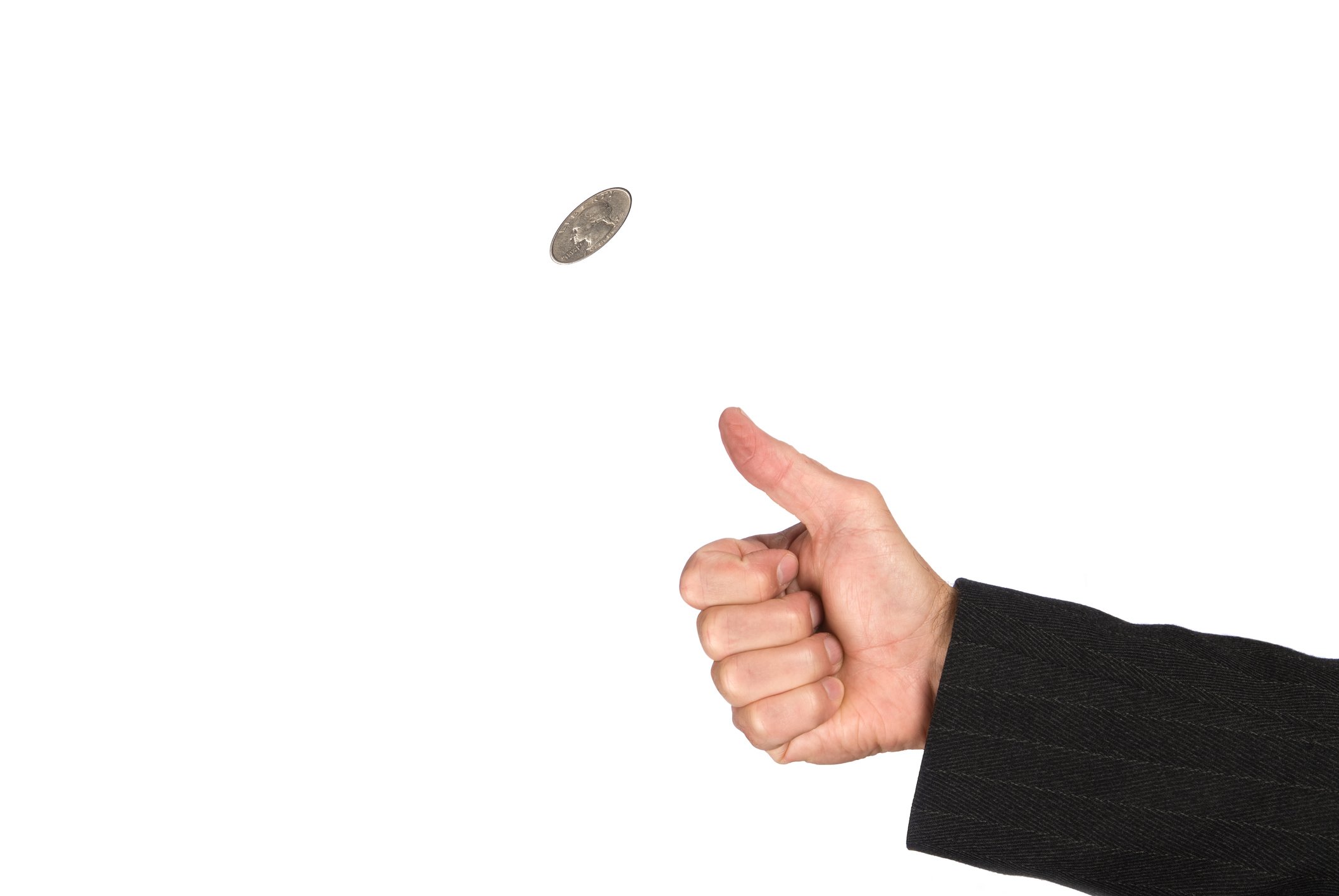 Hand flipping a coin.