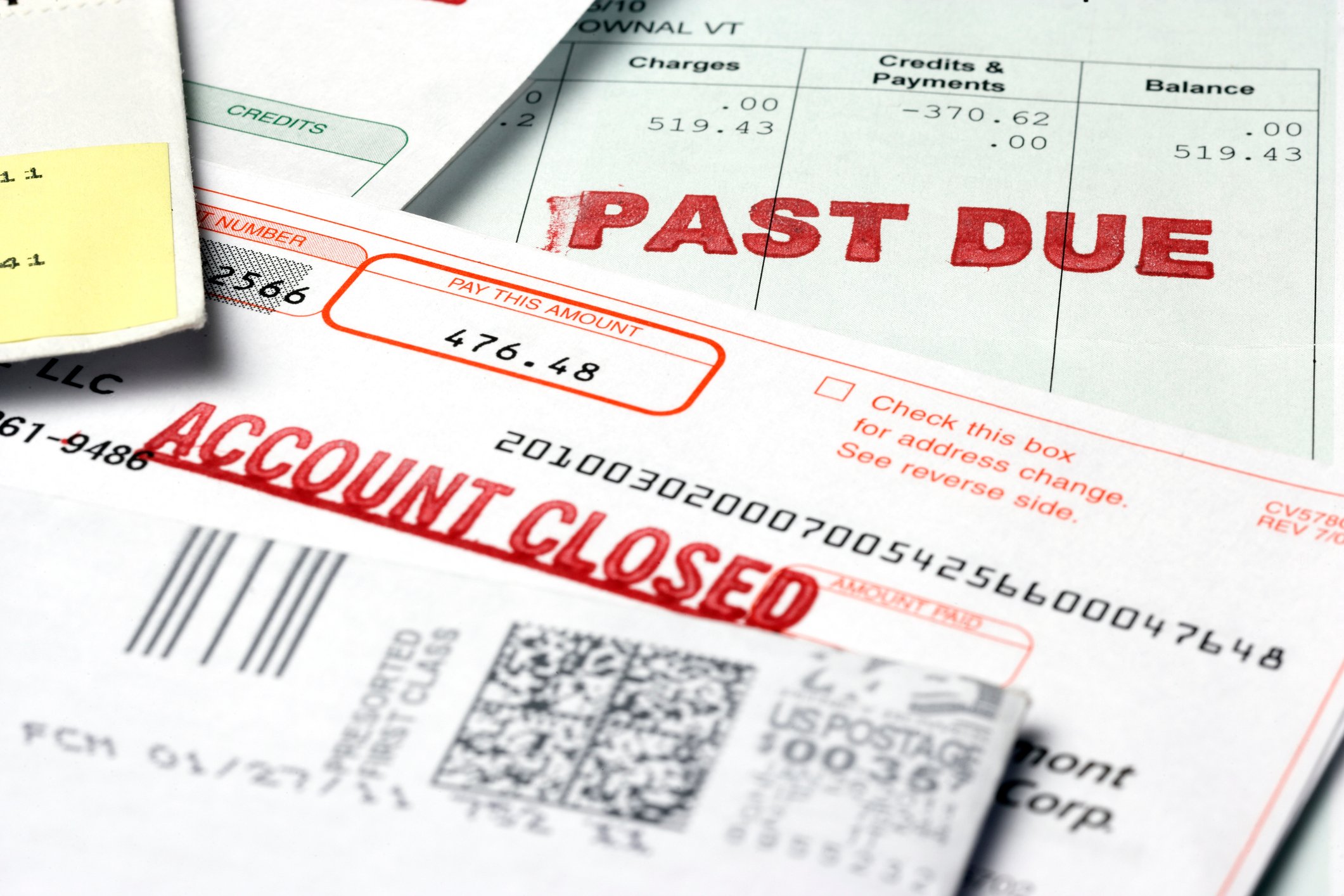 Stack of financial paperwork with past due notice