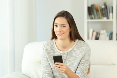woman holding phone_GettyImages-877069240