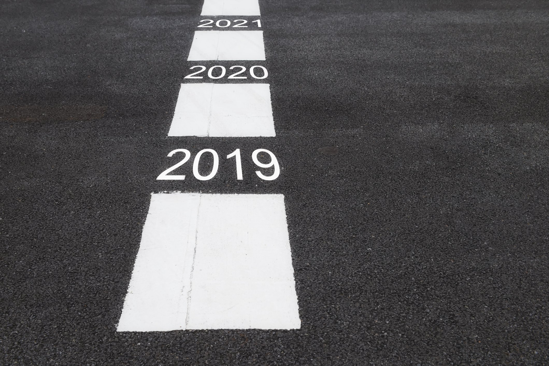 2019, 2020, and 2021 painted between lines on a road's surface
