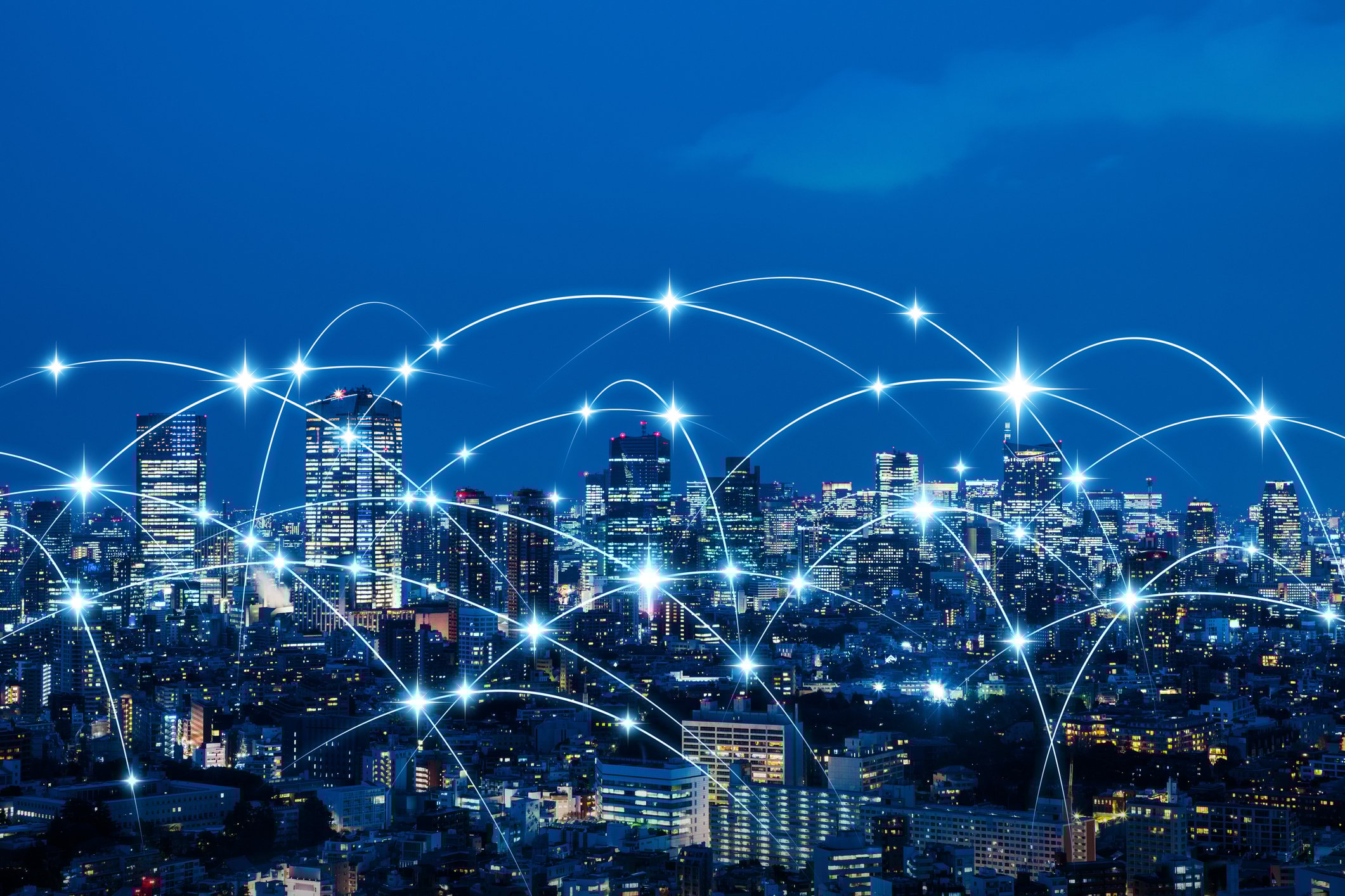 Image of a city skyline at night with connecting dots.