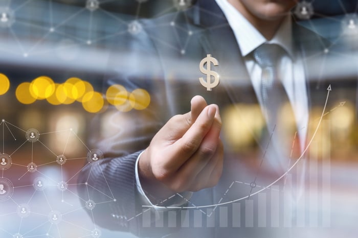 Man with a dollar sign hovering above his hand, superimposed on rising graph.