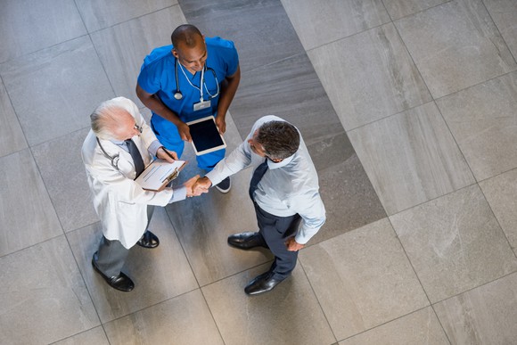 Doctors shaking hands in hallway
