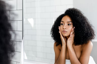 woman putting on face cream