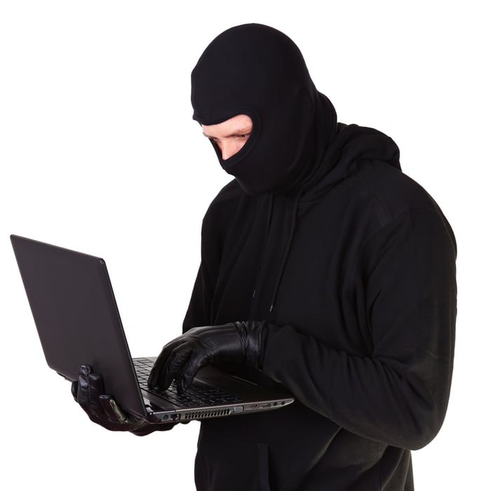 Criminal with laptop in hands