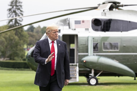 President Trump walking across the south side lawn of the White House. 