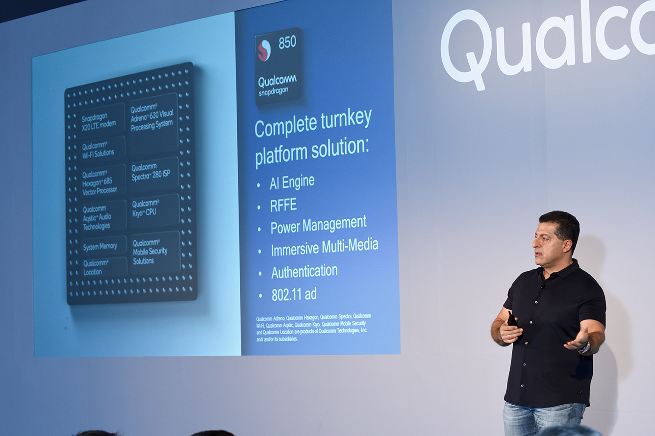 A Qualcomm employee presenting a slide about a Qualcomm mobile chip.