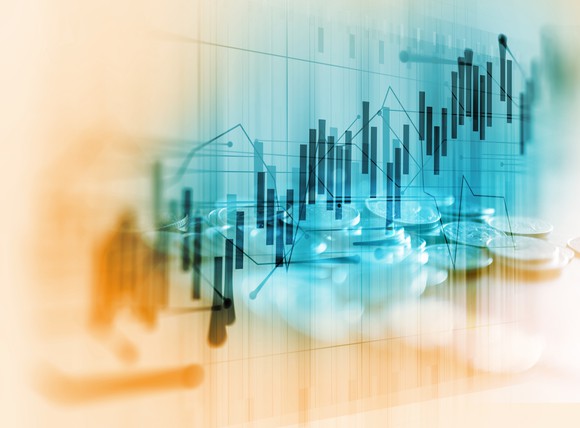 Rising bar graph and stacks of coins.