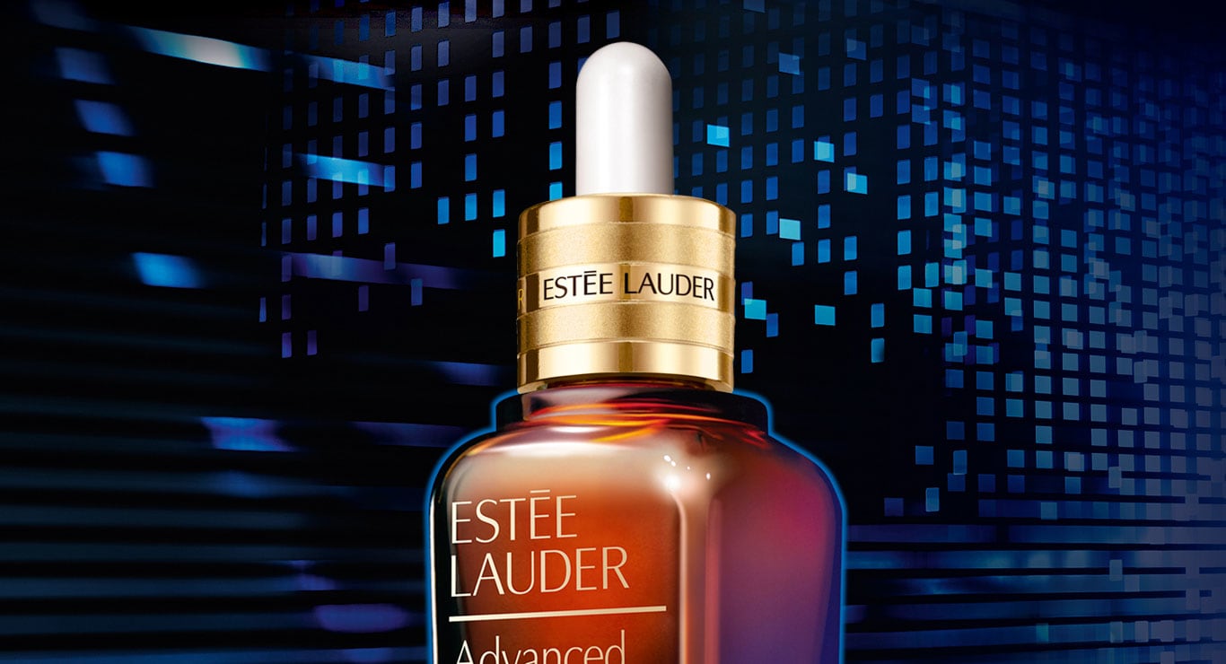 Bottle of Estee Lauder labeled cosmetics in front of a digital landscape.