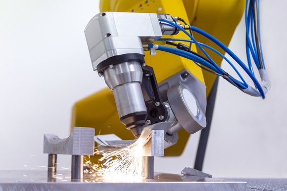 Laser on robotic arm cutting metal