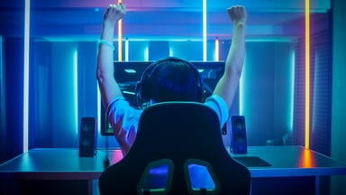 Gamer raising his hands in the air in victory