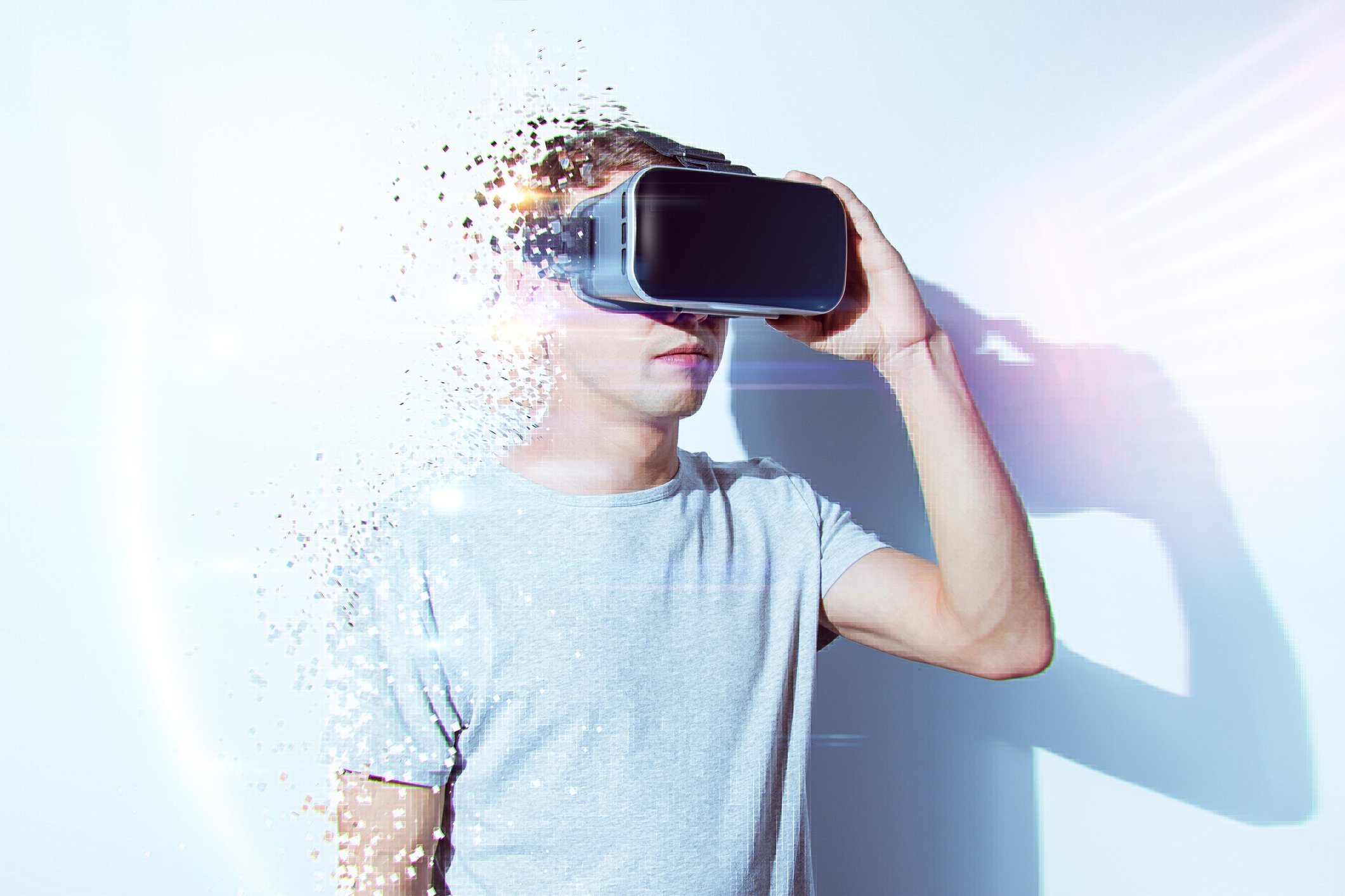 A man "fades away" as he wears an AR/VR headset.
