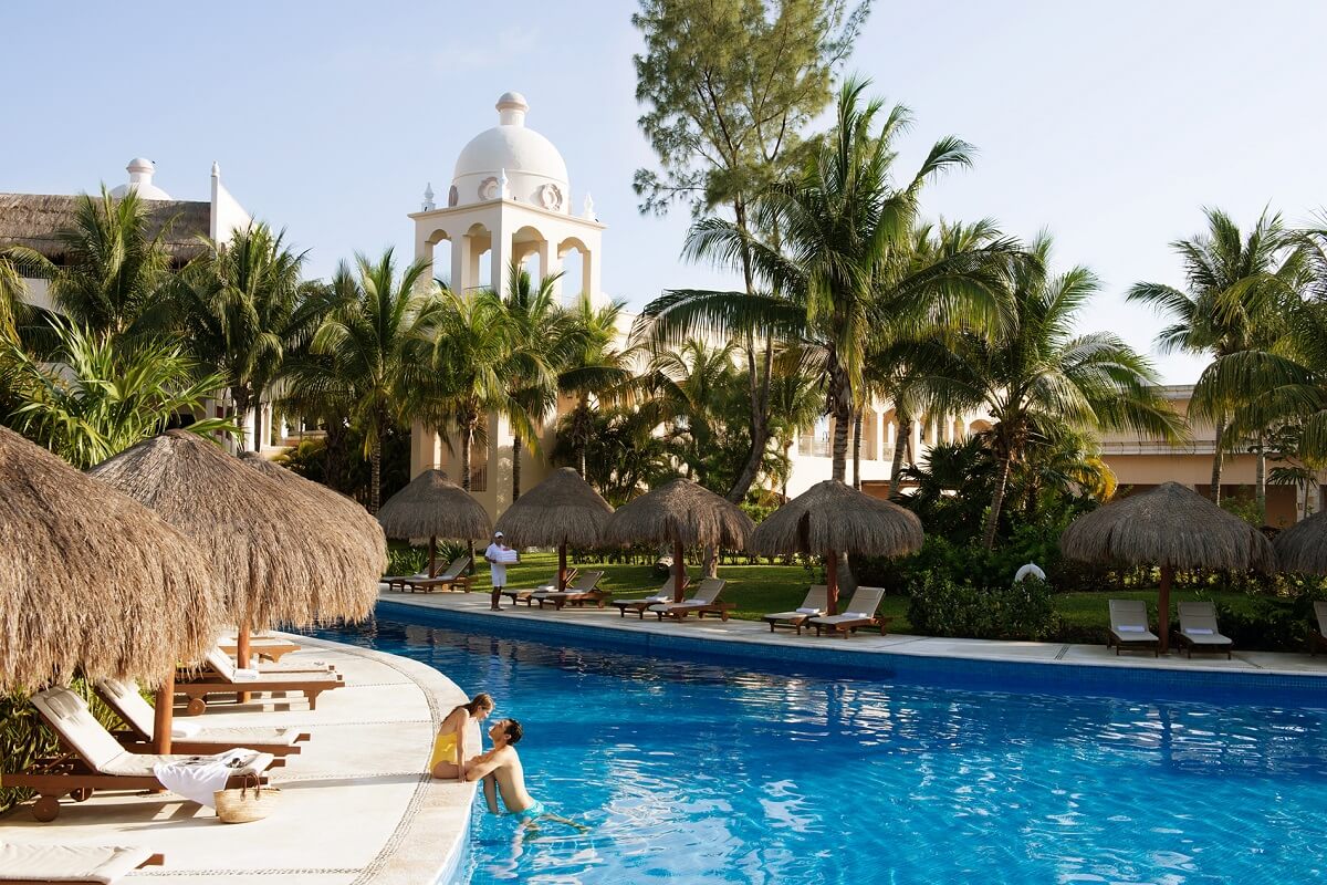 A couple enjoys a hotel pool.